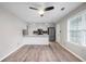 Open-concept kitchen featuring white cabinets, stainless steel appliances, and sleek countertops with modern lighting at 1181 Mannbrook Dr, Stone Mountain, GA 30083