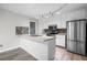 Well-lit kitchen featuring white cabinets, stainless steel appliances, with modern fixtures and tile backsplash at 1181 Mannbrook Dr, Stone Mountain, GA 30083