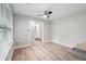 Bright living room with neutral walls, a ceiling fan, and wood-look flooring, creating a comfortable and inviting space at 1181 Mannbrook Dr, Stone Mountain, GA 30083