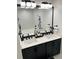 Bathroom featuring double sinks, modern lighting, and white quartz countertop at 2706 Cedar Dr, Lawrenceville, GA 30043