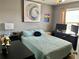 Comfortable bedroom with an art piece and a workspace perfect for studying at 2706 Cedar Dr, Lawrenceville, GA 30043