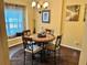Cozy dining area with a round table, four chairs, and a window seat at 2706 Cedar Dr, Lawrenceville, GA 30043
