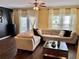 Bright living room with hardwood floors, large sectional couch, and modern accents at 2706 Cedar Dr, Lawrenceville, GA 30043