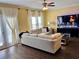 Comfortable living room featuring a large sectional, modern TV, and hardwood floors at 2706 Cedar Dr, Lawrenceville, GA 30043