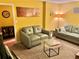 Cozy living room features comfortable sofas, a coffee table, and bright yellow walls at 2706 Cedar Dr, Lawrenceville, GA 30043