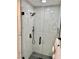 Elegant glass-enclosed shower with black hardware and tiled walls at 2706 Cedar Dr, Lawrenceville, GA 30043
