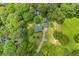 An aerial view of a home, surrounded by lush trees and green spaces, showcasing its secluded and natural setting at 3100 Meadow Trl, Loganville, GA 30052