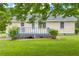Backyard featuring a charming yellow home with a spacious deck, perfect for outdoor entertaining and relaxation at 3100 Meadow Trl, Loganville, GA 30052