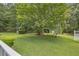 Spacious backyard with lush grass, a large tree, and a gazebo at 3100 Meadow Trl, Loganville, GA 30052