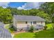 Charming backyard featuring a yellow home with a gray roof, complemented by a spacious deck for outdoor enjoyment at 3100 Meadow Trl, Loganville, GA 30052