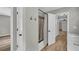 Well-lit bathroom featuring a walk-in shower with glass door, modern fixtures, and access to additional rooms at 3100 Meadow Trl, Loganville, GA 30052
