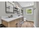 Stylish bathroom showcasing a double sink vanity with modern fixtures, open shelving, and elegant finishes at 3100 Meadow Trl, Loganville, GA 30052