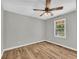 Bedroom featuring hardwood floors, ceiling fan, and natural light through the windows at 3100 Meadow Trl, Loganville, GA 30052