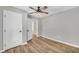 Bedroom with hardwood floors, ceiling fan, closet, and access to additional rooms at 3100 Meadow Trl, Loganville, GA 30052