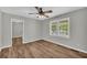 Bedroom with two windows, hardwood floors, and a ceiling fan, providing a cozy feel at 3100 Meadow Trl, Loganville, GA 30052