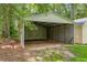 Open carport structure, providing sheltered parking with easy access and protection from the elements at 3100 Meadow Trl, Loganville, GA 30052