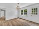 Bright dining room with hardwood floors, wainscoting, and modern light fixture at 3100 Meadow Trl, Loganville, GA 30052