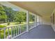 Inviting front porch with a light-colored wood railing and flooring overlooking the landscaped lawn at 3100 Meadow Trl, Loganville, GA 30052