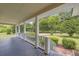 Inviting front porch featuring gray painted floors, white railings, and views of the front yard and surrounding landscape at 3100 Meadow Trl, Loganville, GA 30052