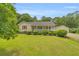 Well-maintained lawn, lush manicured shrubbery and inviting front porch on this charming home with a detached garage at 3100 Meadow Trl, Loganville, GA 30052