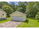 Detached garage with a concrete driveway and well-manicured lawn, offering convenient parking and storage at 3100 Meadow Trl, Loganville, GA 30052