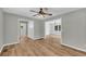 Living room showcasing hardwood floors, ceiling fan, and is open to other areas at 3100 Meadow Trl, Loganville, GA 30052