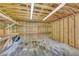 Interior view of an unfinished storage shed with built in shelving at 3100 Meadow Trl, Loganville, GA 30052