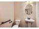 Well-lit powder room featuring a pedestal sink and an oval mirror at 3280 Hallmark Ln, Buford, GA 30519