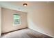 Bedroom with beige walls, a window, and neutral carpet at 3280 Hallmark Ln, Buford, GA 30519