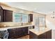 Bright kitchen with granite counters, stainless steel appliances, and dark wood cabinets at 3280 Hallmark Ln, Buford, GA 30519