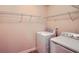 Bright laundry room featuring washer, dryer, and wire shelving for optimal storage at 3280 Hallmark Ln, Buford, GA 30519