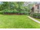 Spacious backyard featuring lush green grass and mature trees offering privacy and natural beauty at 5609 Twin Oak Dr, Douglasville, GA 30135