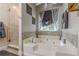 Bathroom with a tub with jets, tan tile, and clear shower door at 5609 Twin Oak Dr, Douglasville, GA 30135
