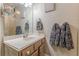 Bathroom features a vanity with a framed mirror, cabinet, and modern towel racks at 5609 Twin Oak Dr, Douglasville, GA 30135