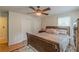 This bedroom has a ceiling fan, wood floors and a large bed at 5609 Twin Oak Dr, Douglasville, GA 30135