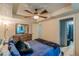 Bedroom with wood floors, ceiling fan, and attached bathroom at 5609 Twin Oak Dr, Douglasville, GA 30135