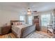 Comfortable bedroom with a ceiling fan, natural lighting, and hardwood floors at 5609 Twin Oak Dr, Douglasville, GA 30135