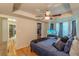 Bedroom with wood floors, ceiling fan, walk-in closet, and natural lighting at 5609 Twin Oak Dr, Douglasville, GA 30135