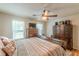 Cozy bedroom features natural light, a ceiling fan, and dark wood furniture at 5609 Twin Oak Dr, Douglasville, GA 30135