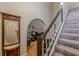 Entryway boasting wood floors, a staircase with carpeted steps, and an arched entryway to the living room at 5609 Twin Oak Dr, Douglasville, GA 30135