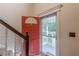 Welcoming foyer with a red front door and glass storm door allowing natural light to enter the home at 5609 Twin Oak Dr, Douglasville, GA 30135
