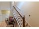 Spacious entryway with hardwood floors, staircase with carpeted steps, and a hall table with seating at 5609 Twin Oak Dr, Douglasville, GA 30135