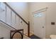 Charming entryway with a white front door featuring decorative glass and a staircase with painted wood trim at 5609 Twin Oak Dr, Douglasville, GA 30135