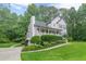A beautifully landscaped home with a lush lawn and mature trees, featuring a charming front porch at 5609 Twin Oak Dr, Douglasville, GA 30135