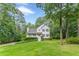 Traditional two-story home with a welcoming front porch and beautiful green lawn surrounded by mature trees at 5609 Twin Oak Dr, Douglasville, GA 30135