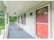 Inviting front porch with rocking chairs and an orange front door, perfect for relaxing outdoors at 5609 Twin Oak Dr, Douglasville, GA 30135