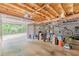 Unfinished garage with exposed wood beams and storage at 5609 Twin Oak Dr, Douglasville, GA 30135