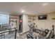 A home gym featuring a treadmill, weights, and TV at 5609 Twin Oak Dr, Douglasville, GA 30135