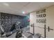 A home gym featuring a treadmill, weights, and accent wall at 5609 Twin Oak Dr, Douglasville, GA 30135