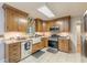 Well-appointed kitchen features custom cabinets, granite counters, stainless appliances at 5609 Twin Oak Dr, Douglasville, GA 30135